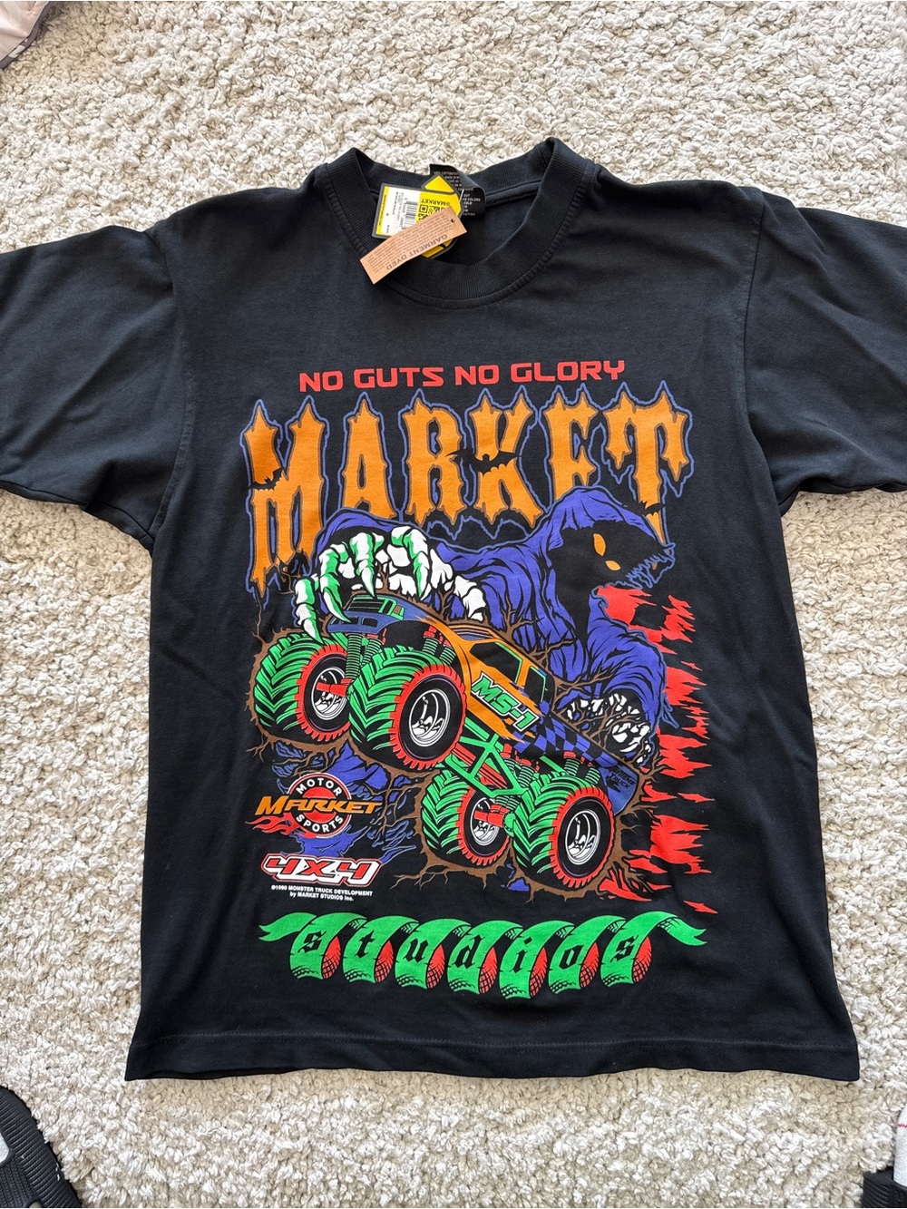 Market Black Tee with Neon Green & Orange Monster Truck Graphic